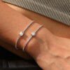 High quality sterling silver tennis bracelet featuring a 1ct emerald-cut moissanite center stone and cubic zirconia side accents | D-Carats.