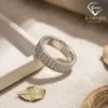 Moissanite eternity band ring in platinum-plated silver 17 Close-up angled view of a silver eternity band ring featuring three rows of shimmering moissanite stones