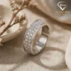 Moissanite eternity band ring in platinum-plated silver 19 Close-up angle of a platinum-plated silver eternity band ring featuring three rows of sparkling round moissanite stones
