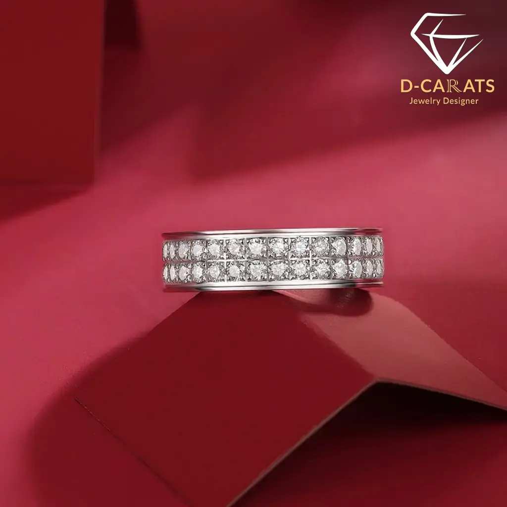 Moissanite eternity band ring in platinum-plated silver 13 Side view of a double-row moissanite eternity band ring in polished silver resting on a geometric red surface