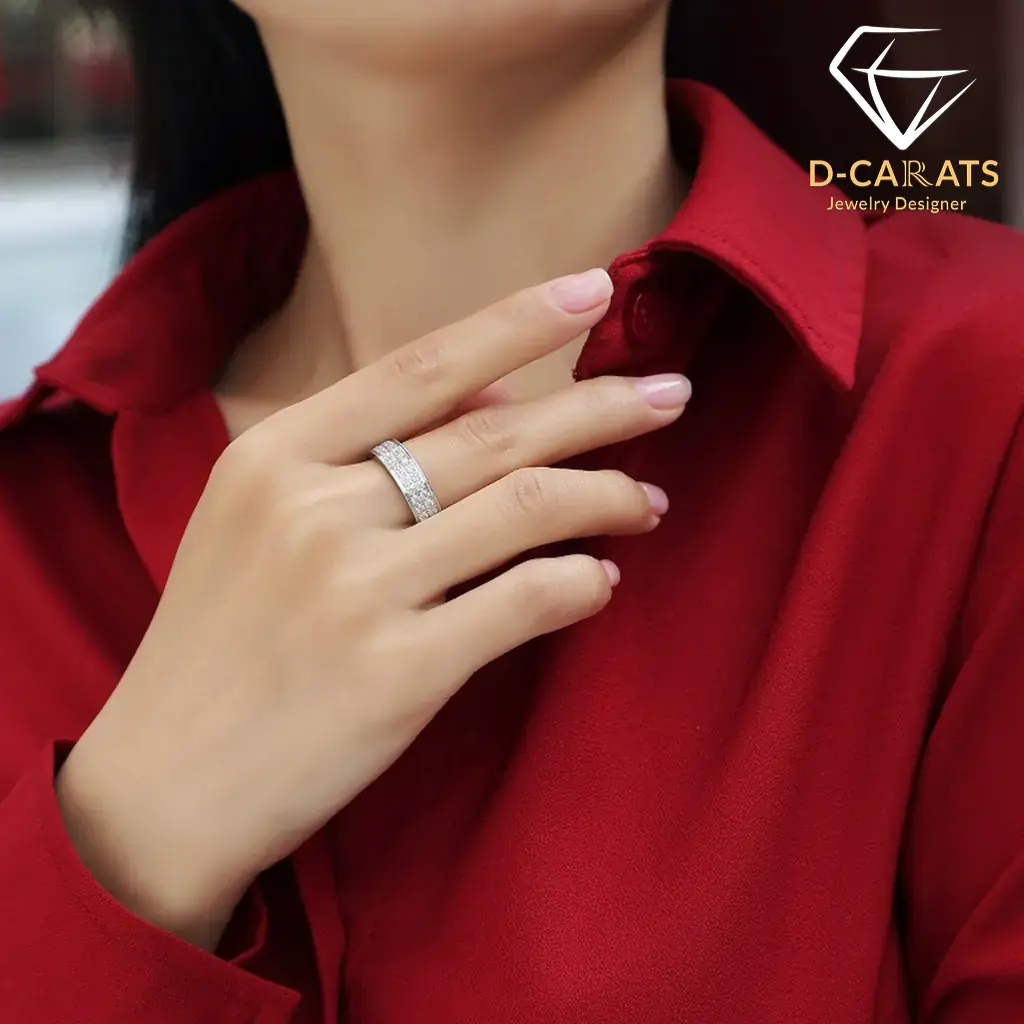 Moissanite eternity band ring in platinum-plated silver 14 Close-up of a woman wearing a sparkling moissanite eternity band ring on her finger against a deep red fabric shirt