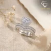 Moissanite Heart Halo Engagement Ring Set 20 Close-up of a silver heart shaped engagement ring set with a shimmering moissanite center stone and pavé diamond bands