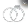 Moissanite Heart Halo Engagement Ring Set 28 Side view of a silver heart shaped engagement ring set featuring shimmering pavé diamonds along the polished bands