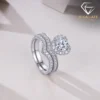 Moissanite Heart Halo Engagement Ring Set 24 Close-up side view of a silver heart shaped engagement ring set featuring a shimmering moissanite halo and paved band