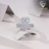 Moissanite Heart Halo Engagement Ring Set 25 Close-up of a sparkling heart shaped engagement ring set with a diamond halo and matching v-shaped wedding band