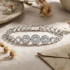 Sparkling platinum S925 silver bracelet featuring a triple halo moissanite center stone in a polished circular layout