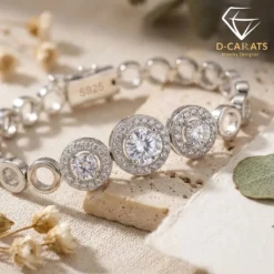 Close-up of polished silver triple halo gemstones resting on a textured stone surface with soft natural lighting