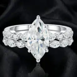 Close-up view of a marquise-cut moissanite diamond engagement ring set | D-Carats.