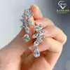 C;ose-up view of pear cut moissanite drop earrings in sterling silver | D-Carats.
