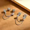 Sterling silver double piercing earrings with moissanite studs connected by delicate chain | D-Carats.