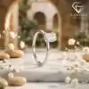 Silver band featuring a horizontal east west emerald cut moissanite stone set on a white marble plinth with baby breath