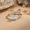 East-west emerald cut moissanite ring in 925 silver 2 Silver band featuring an east west emerald cut moissanite stone with S925 hallmark in a soft sunlit setting