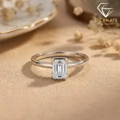 Silver band featuring an east west emerald cut moissanite stone with S925 hallmark in a soft sunlit setting