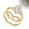 Marquise Moissanite Bridal Ring Set 26 Close-up of a gold marquise moissanite bridal ring set featuring a curved V-shaped band with small shimmering stones