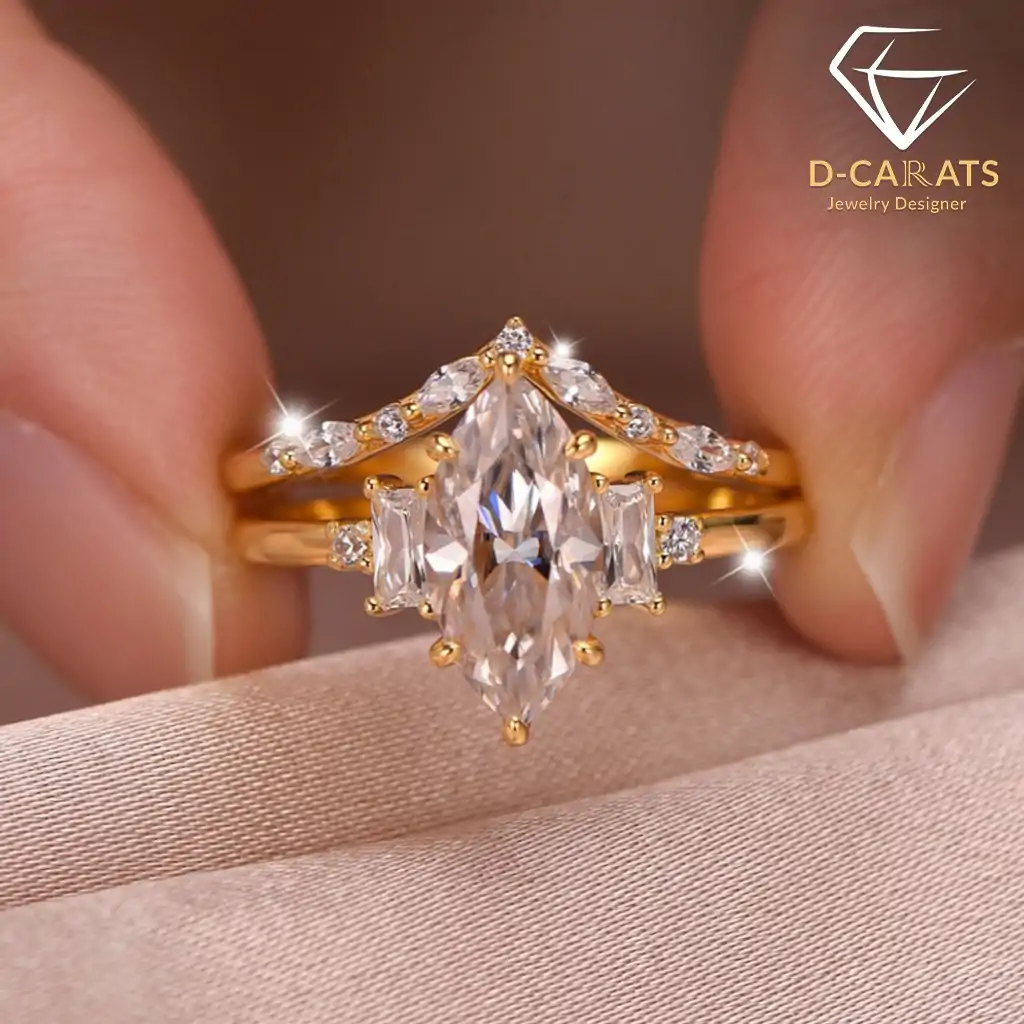 Marquise Moissanite Bridal Ring Set 11 Close-up of a gold marquise moissanite bridal ring set held by fingers, showing brilliant baguette side stone details