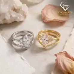 Gold and silver marquise moissanite bridal ring sets displayed side by side among soft petals and white crystals