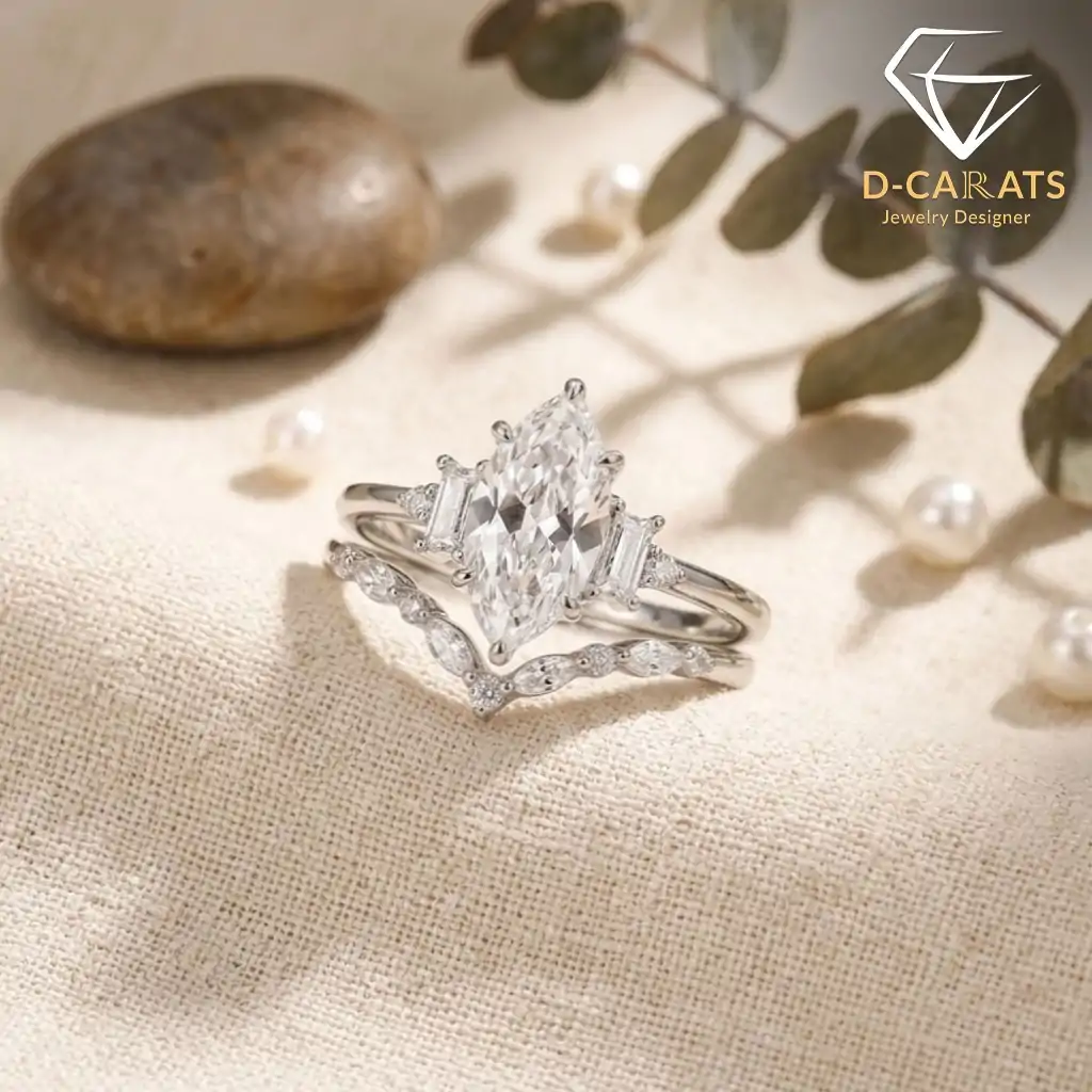 Marquise Moissanite Bridal Ring Set 4 Silver marquise moissanite bridal ring set with baguette accents and a curved band on beige linen with soft natural light