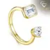 Close-up of a gold moissanite toi moi ring featuring one emerald cut and one round brilliant stone in a bypass design