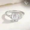 Three-stone emerald cut ring in 925 silver 15 Close-up of a polished 925 silver three stone emerald cut ring with shimmering clear crystals and a sleek band