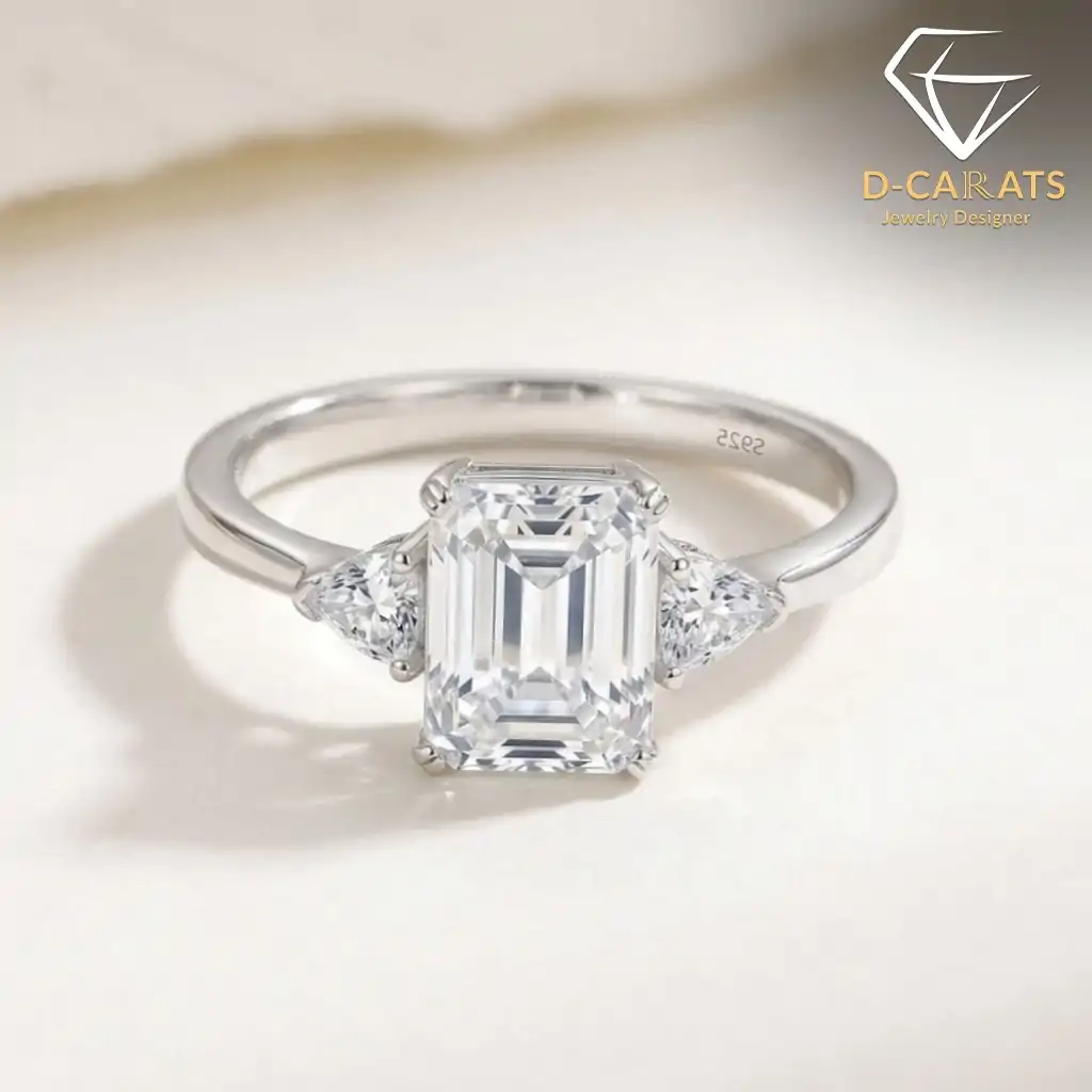 Three-stone emerald cut ring in 925 silver 5 Close-up of a polished 925 silver three stone emerald cut ring with shimmering clear crystals and a sleek band
