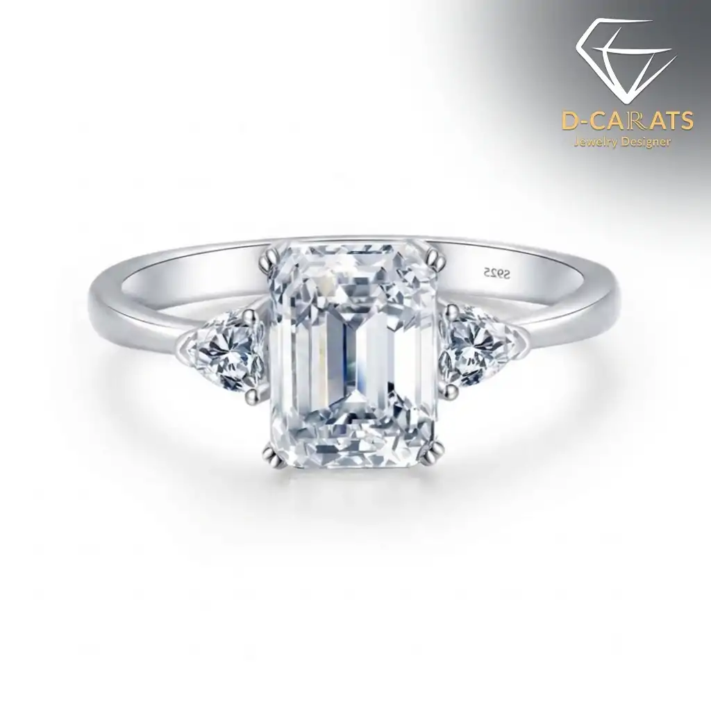 Three-stone emerald cut ring in 925 silver 6 Close-up of a polished silver three stone emerald cut ring featuring a large central gem and two smaller side diamonds